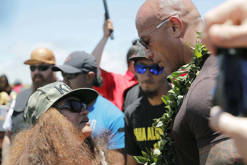 Actor Dwayne "The Rock" Johnson, right, is greeted by community leader Pua Case durin ...