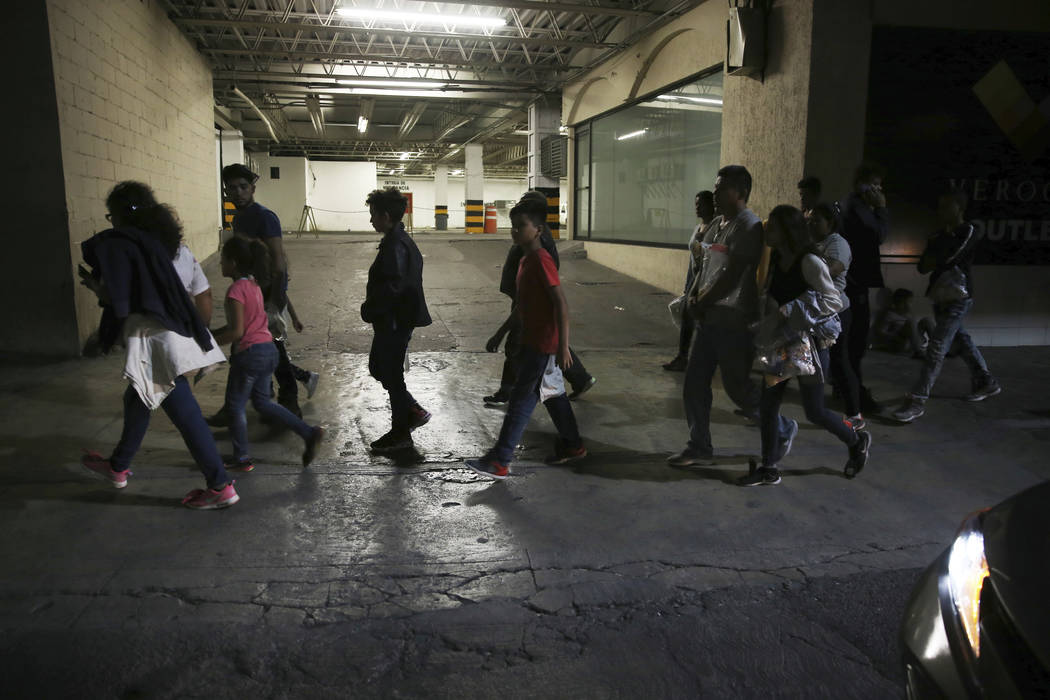 In this July 18, 2019 photo, migrants who have just been bused by Mexican Authorities from Nuev ...