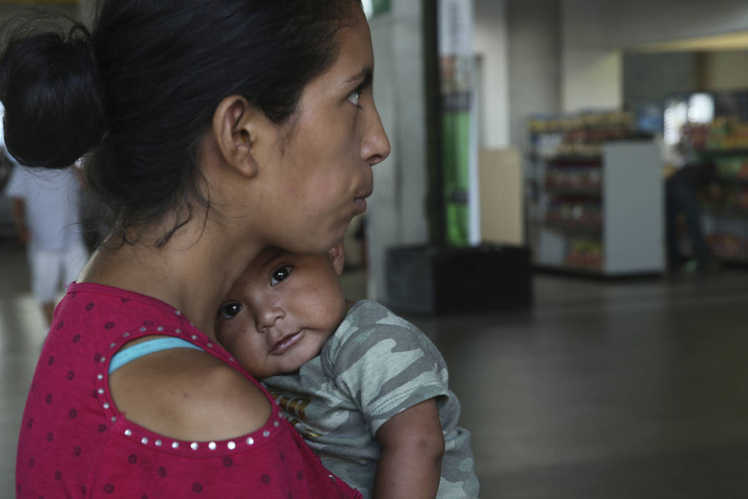 In this July 18, 2019 photo, Maria del Carmen and her 7-month-old baby stand on a sidewalk afte ...