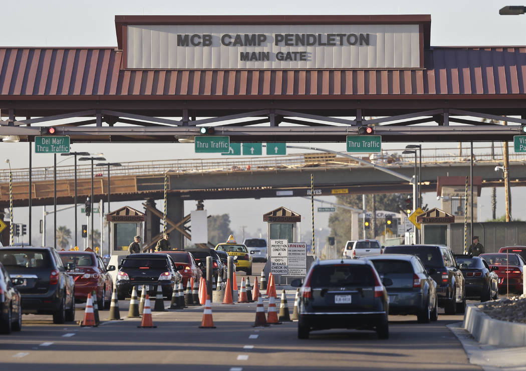 FILE - In this Nov. 13, 2013 file photo vehicles file through the main gate of Camp Pendleton M ...