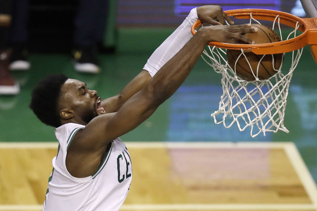 Boston Celtics guard Jaylen Brown dunks against the Cleveland Cavaliers during the second half ...