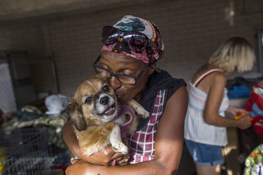 Brenda Shelton kisses her dog Honey Bell at the Courtyard Homeless Resource Center in Las Vegas ...