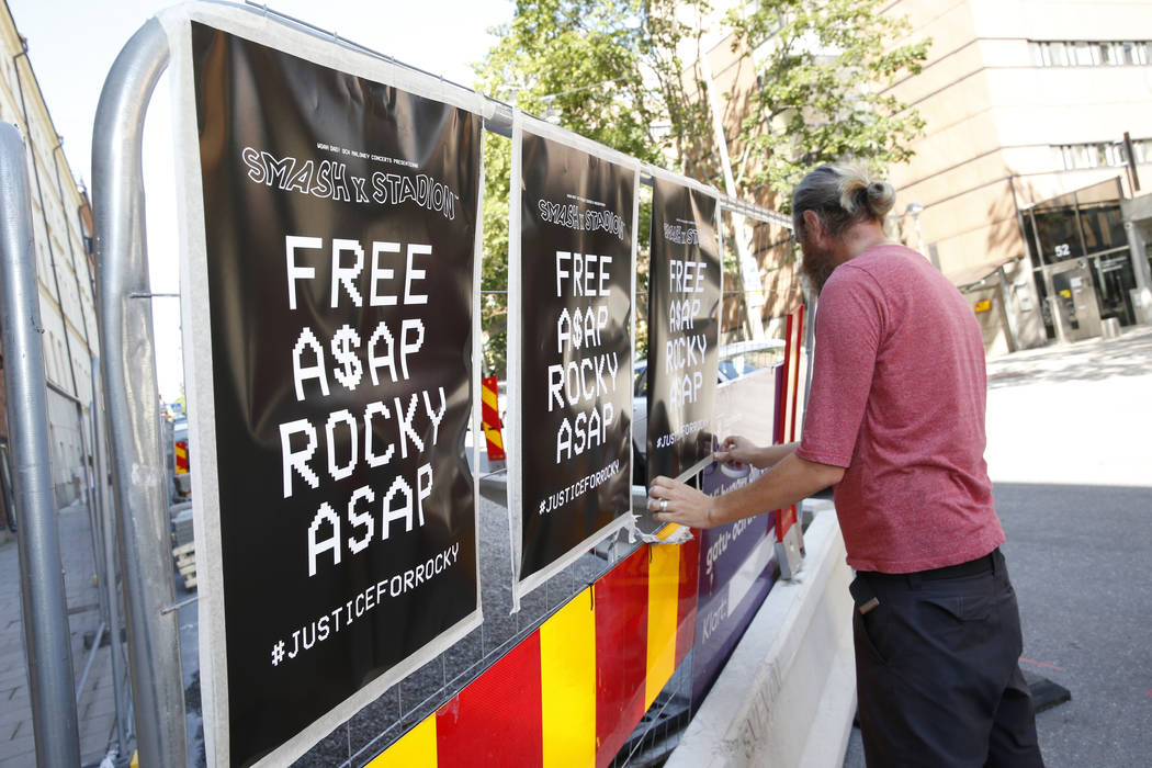 A man displays posters in support of US rapper A$AP Rocky, real name Rakim Mayers, outside the ...