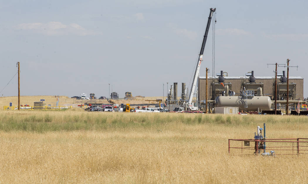 In this photo taken Wednesday, July 24, 2019, authorities investigate the scene in the distance ...