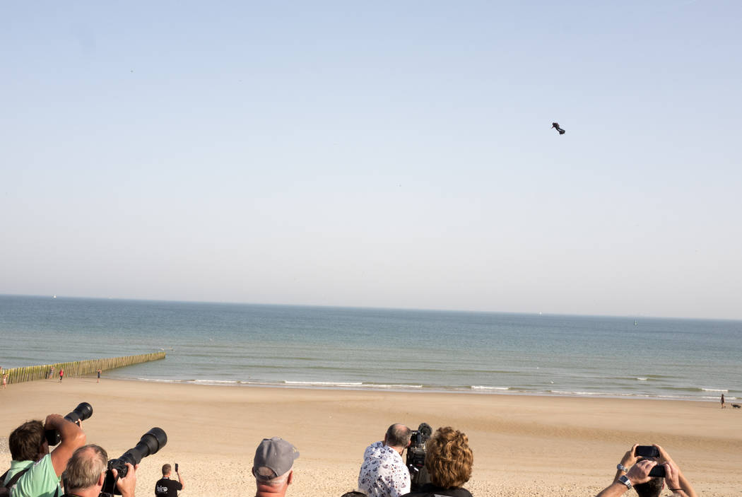 People watch as Franky Zapata, a 40-year-old inventor, takes to the air in Sangatte, Northern F ...