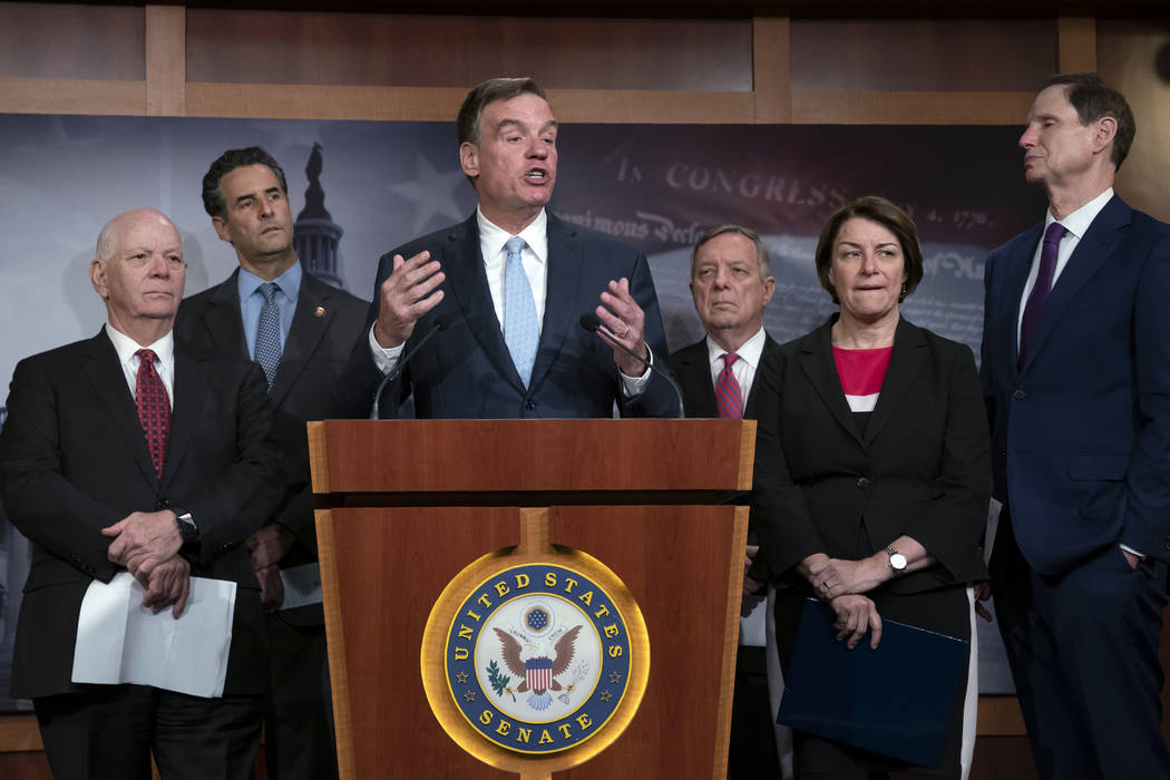 Sen. Mark Warner, D-Va., vice-chair of the Senate Intelligence Committee, is joined by fellow D ...