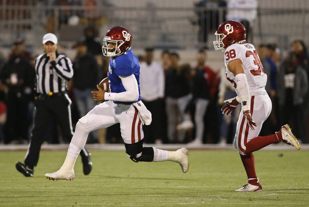 Oklahoma quarterback Jalen Hurts (1) is pursued by linebacker Bryan Mead (38) during the NCAA c ...