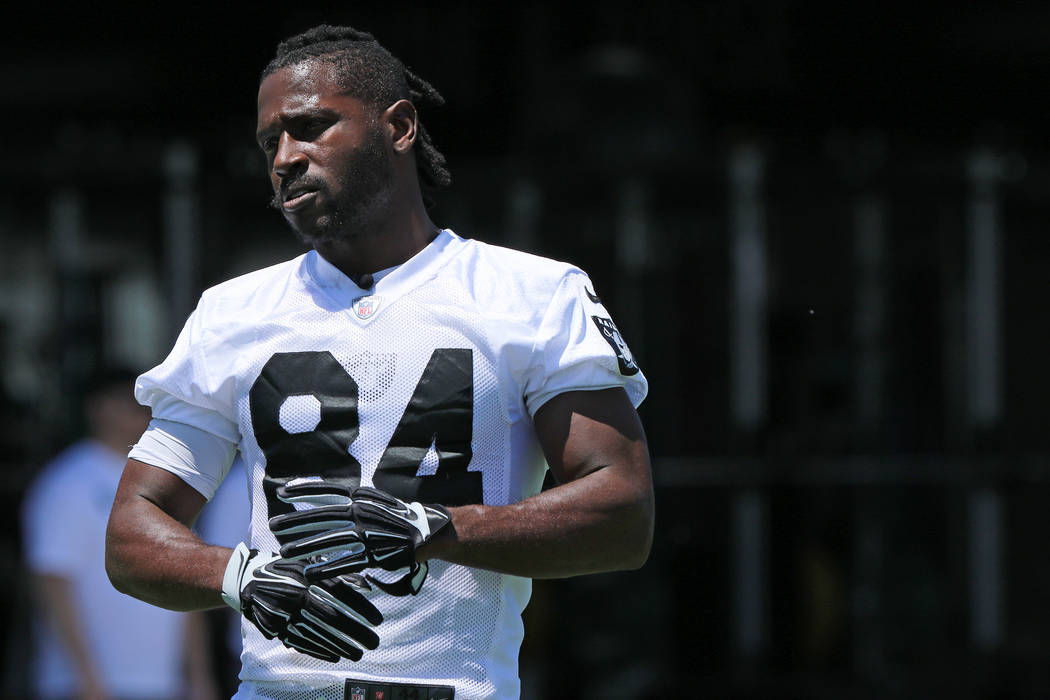 Oakland Raiders wide receiver Antonio Brown (84) stretches on the sideline during mandatory min ...