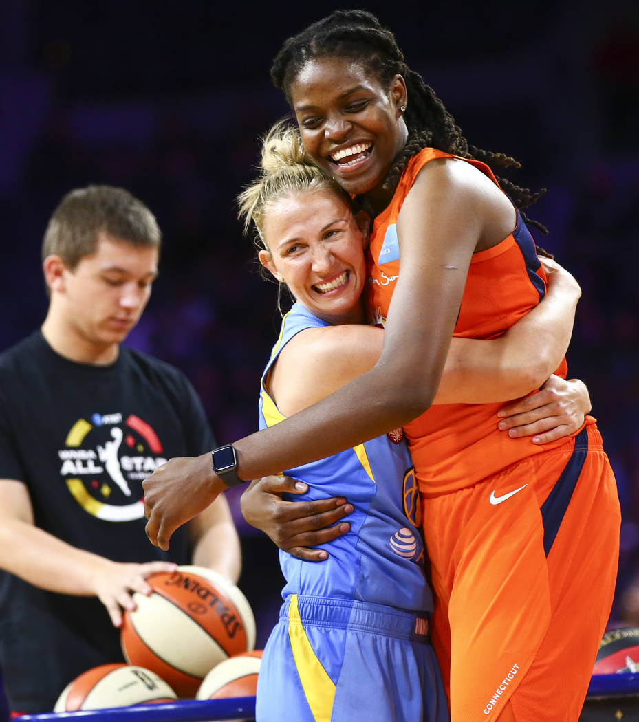 Chicago Sky's Courtney Vandersloot, left, hugs Connecticut Sun's Jonquel Jones during the WNBA ...