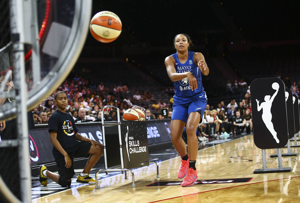 Minnesota Lynx's Napheesa Collier competes in an obstacle course involving passing and shooting ...
