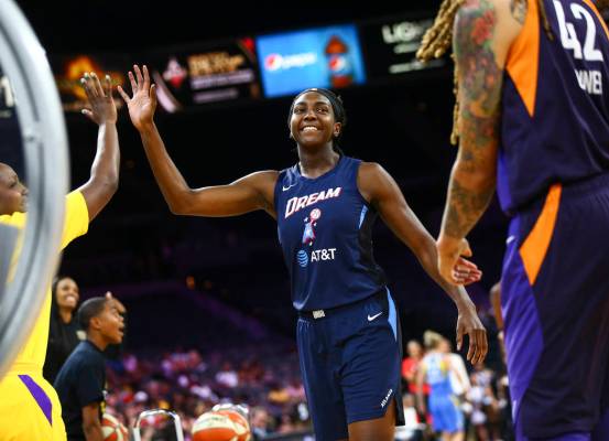 Atlanta Dream's Elizabeth Williams celebrates after competing in an obstacle course involving p ...