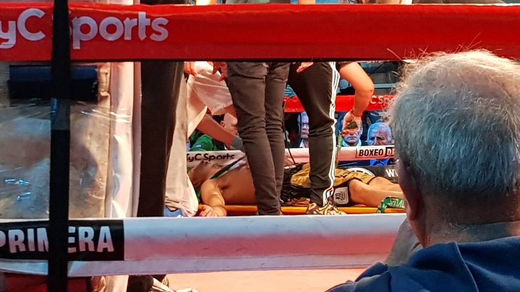 Argentine boxer Hugo Santillan is placed on a stretcher after he collapsed at the end of a WBC ...