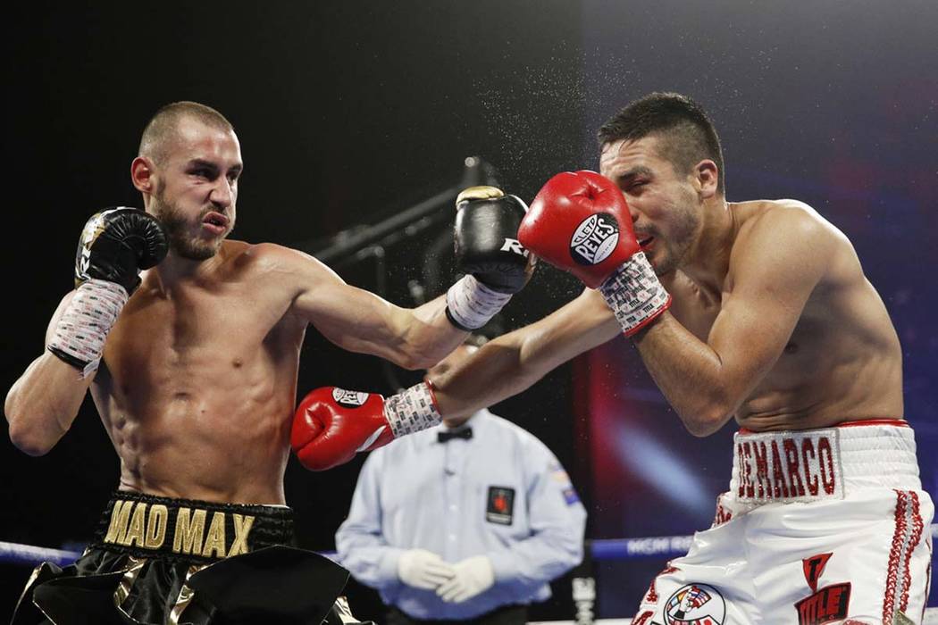 Maxim Dadashev of Russia, left, hits Antonio DeMarco of Mexico during a junior welterweight bou ...