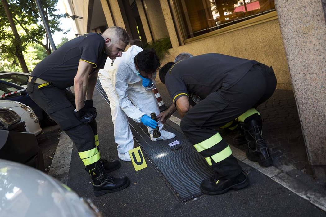 In this picture taken Friday, July 26, 2019 investigators are seen on the scene where an Italia ...