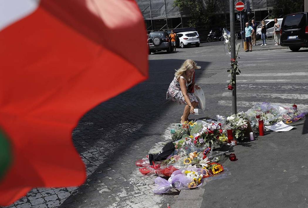 A woman leaves a note in memory on the spot where Mario Cerciello Rega was stabbed to death, in ...