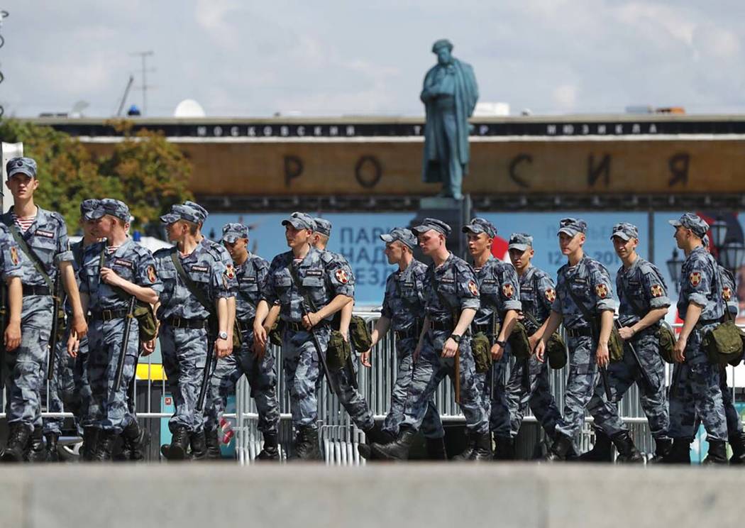 Russian policemen prepare to block a street prior to an unsanctioned rally in the center of Mos ...