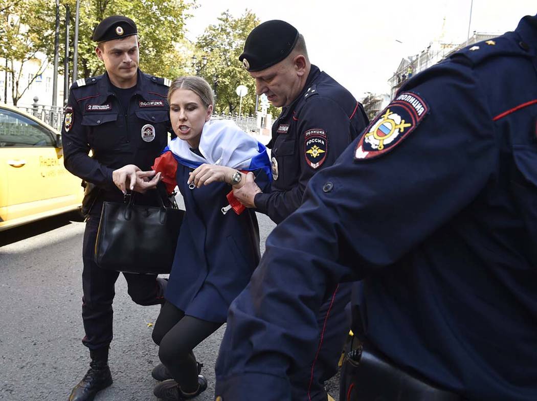 Police officers detain an opposition candidate and lawyer at the Foundation for Fighting Corrup ...