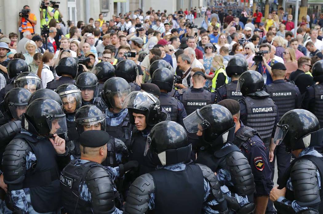 Police block a street prior to an unsanctioned rally in the center of Moscow, Russia, Saturday, ...