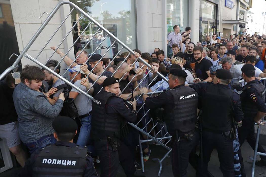 Protesters clash with police during an unsanctioned rally in the center of Moscow, Russia, Satu ...