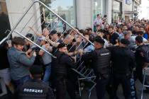 Protesters clash with police during an unsanctioned rally in the center of Moscow, Russia, Satu ...