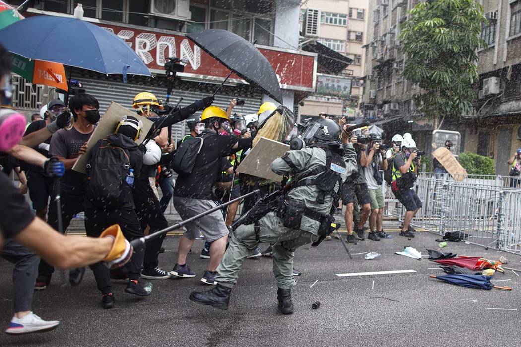 Protesters clash with police in Yuen Long district in Hong Kong on Saturday, July 27, 2019. Pol ...