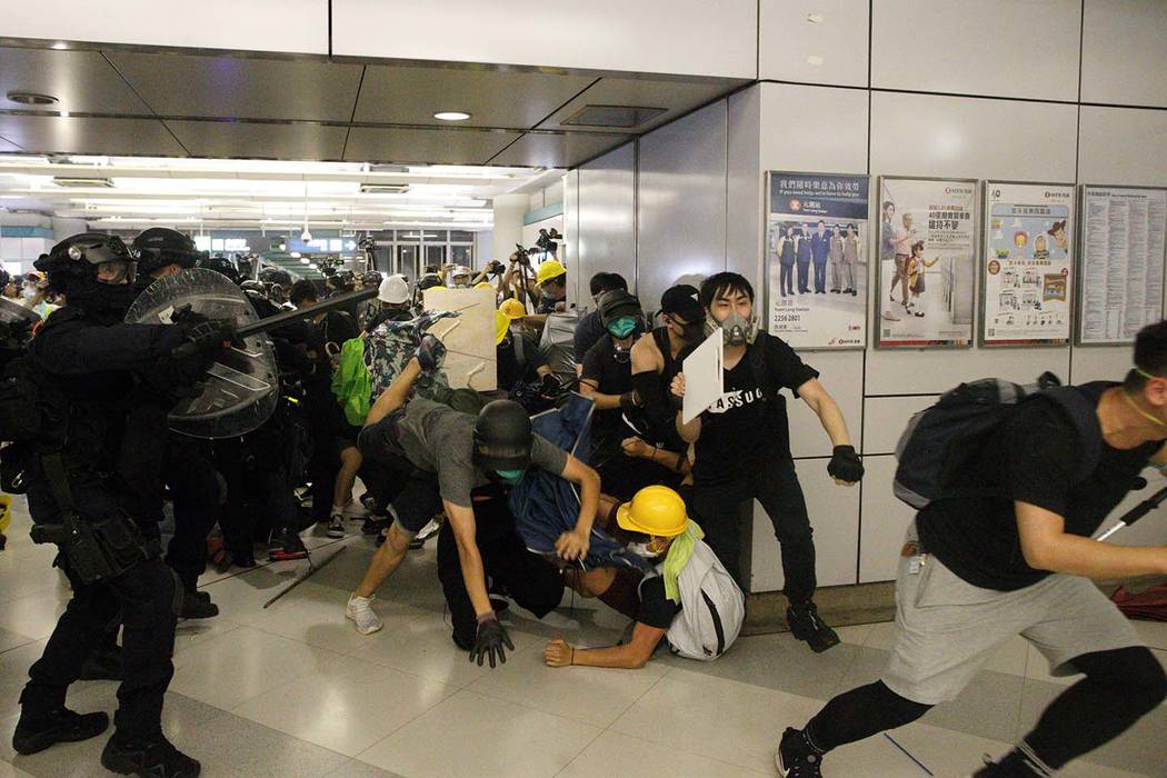 Special Tactical Squad officers attack protesters with batons who refused to disperse from a tr ...