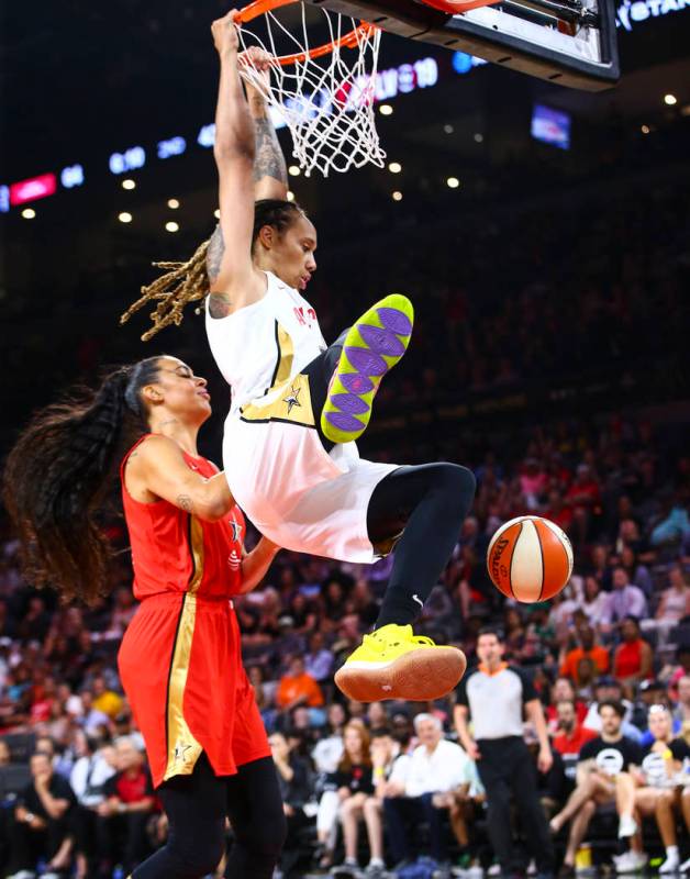 Phoenix Mercury's Brittney Griner dunks in front of Las Vegas Aces' Liz Cambage during the firs ...