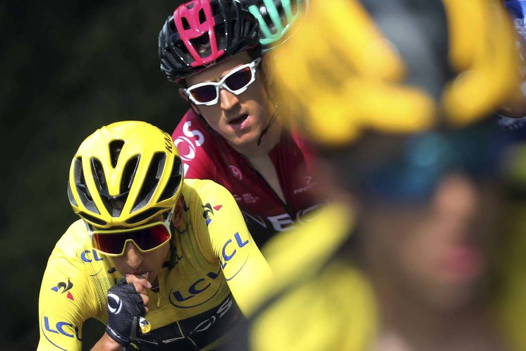 Colombia's Egan Bernal wearing the overall leader's yellow jersey rides with Britain's Geraint ...