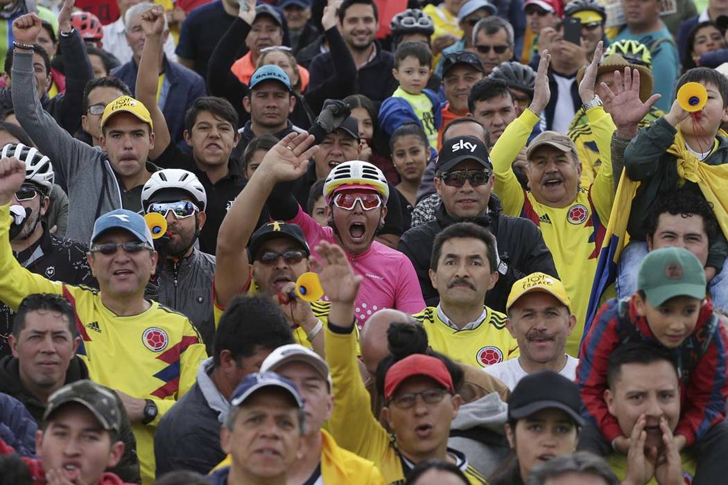 Cycling fans celebrate as they watch on a giant screen Colombia's Egan Bernal performance in th ...