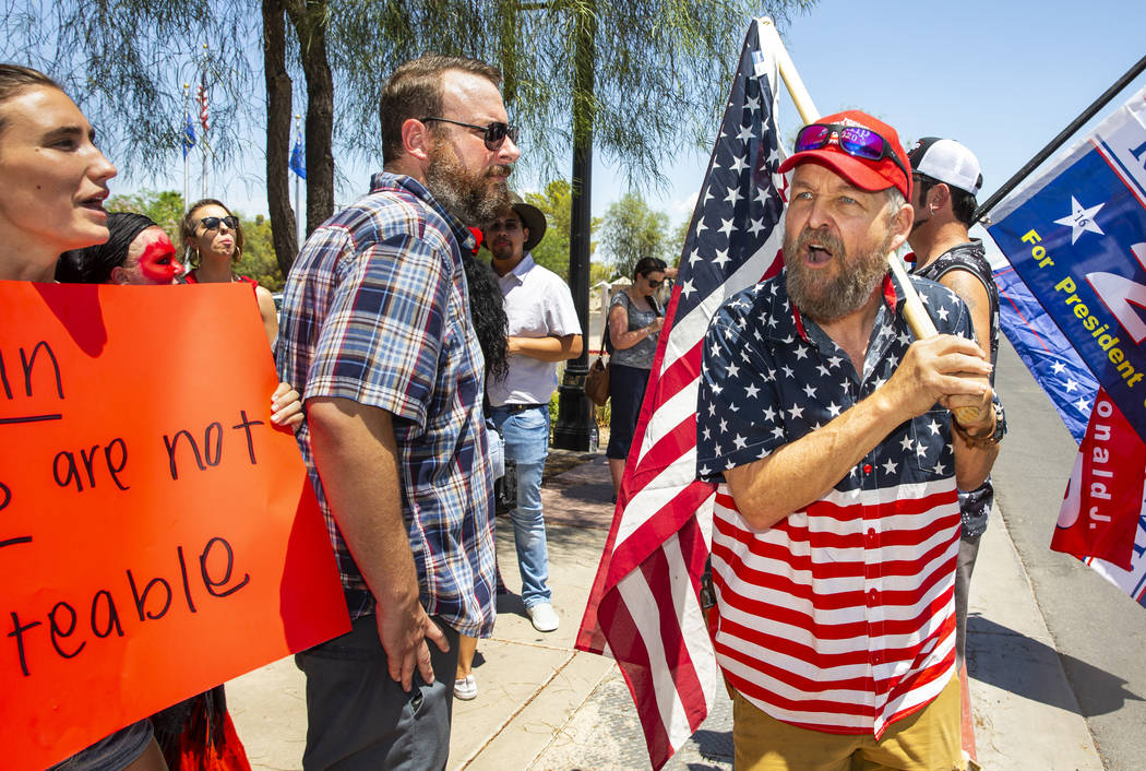 Counter protester John Eakins, right, yells some adversarial comments back to protestors Dylan ...