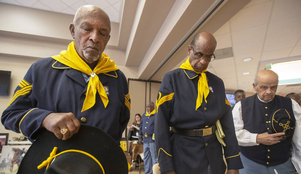 Buffalo Soldier members William Crenshaw, left, Ollie Henry and Fred Hampton pray during Buffal ...