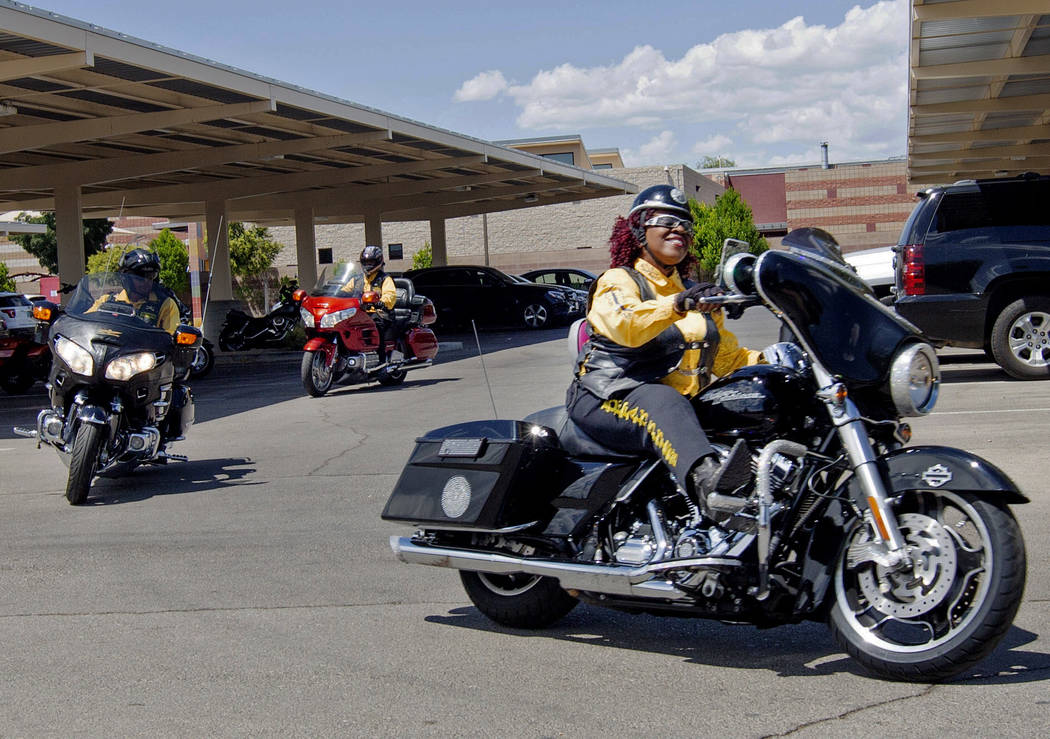 Buffalo Soldiers motorcyclist Judy Ann Young, right, pulls into Doolittle Senior Center for Buf ...