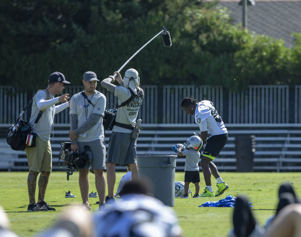 Oakland Raiders wide receiver Antonio Brown (84) plays on the sideline with his sons as he is f ...