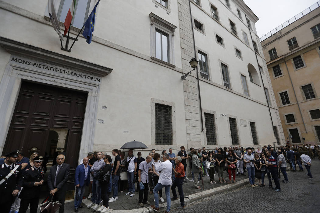 People line up to pay respect in the church where Carabinieri officer Mario Cerciello Rega was ...