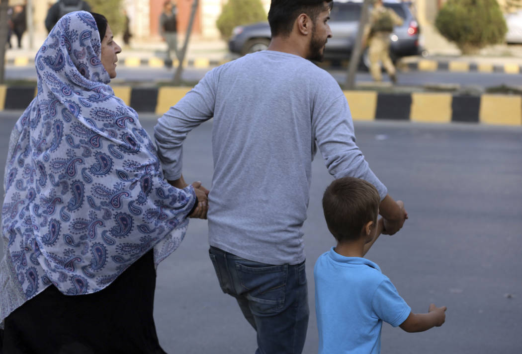 Afghan family flee from near the site of a deadly attack in Kabul, Afghanistan, Sunday, July 28 ...