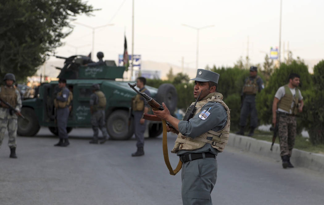 Afghan security personnel secure the site of an attack in Kabul, Afghanistan, Sunday, July 28, ...