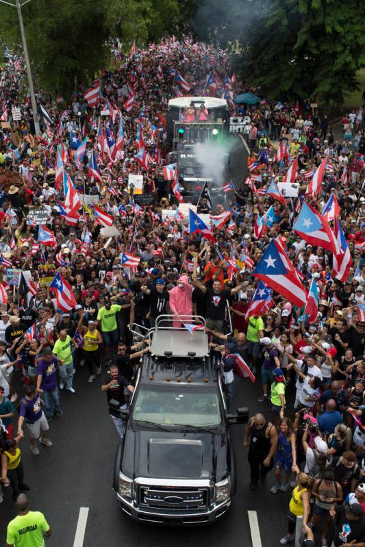 Puerto Rican singer Rene Perez Joglar, also known has Residente, center left in blue cap, and B ...