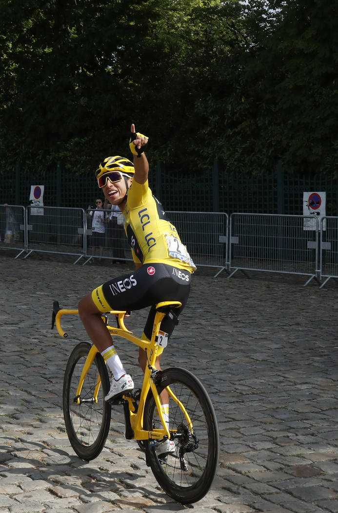 Colombia's Egan Bernal wearing the overall leader's yellow jersey waves as he arrives for the s ...