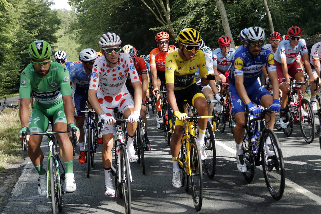 Colombia's Egan Bernal wearing the overall leader's yellow jersey, France's Romain Bardet weari ...