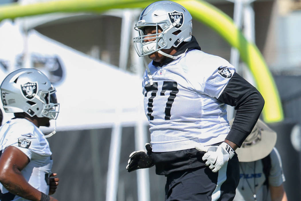 Oakland Raiders running back Jalen Richard (30) and offensive tackle Trent Brown (77) run past ...