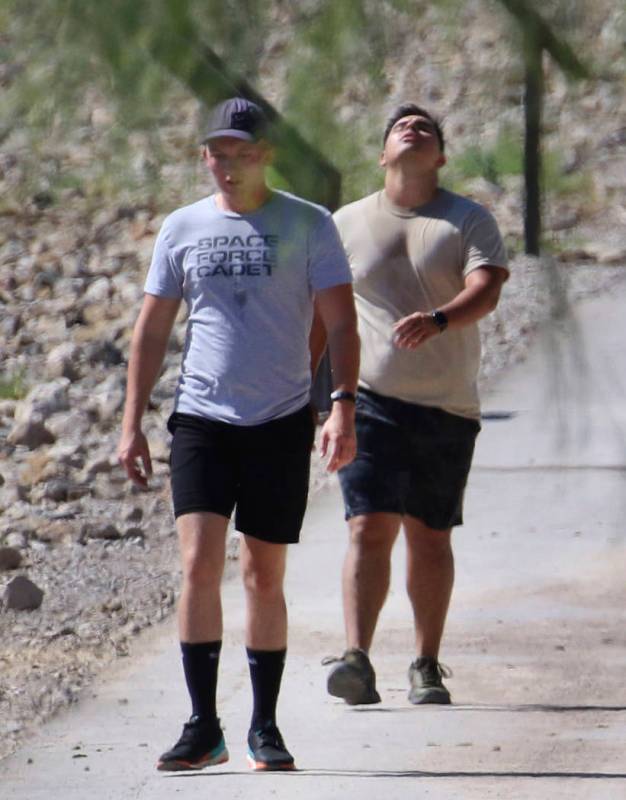 Two men walk at Cornerstone Park during a hot morning on Monday, July 29, 2019, in Henderson. ( ...