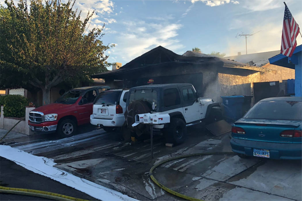 Crews battle a fire at a home in the 600 block of Watkins Drive in Las Vegas on Sunday, July 28 ...