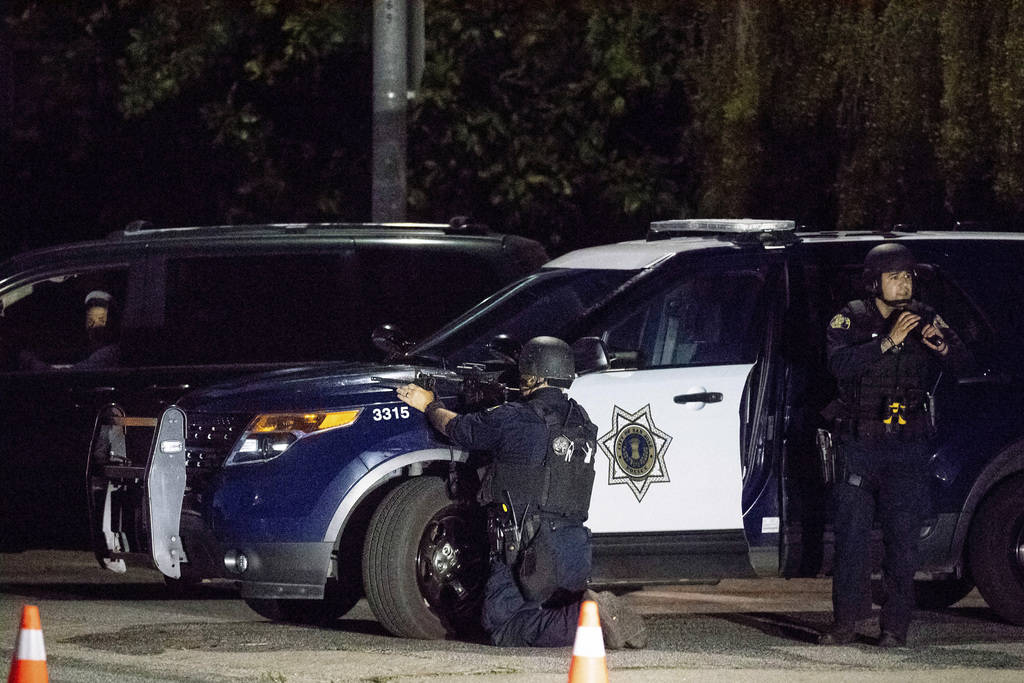 Police stay focused on a target after a deadly shooting at the Gilroy Garlic Festival in Gilroy ...