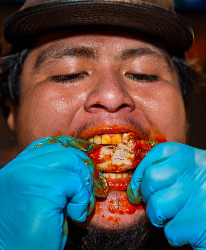 Competitor Alejandro Pascacio digs into a wing as PT's Ranch hosts a $4,000 wing-eating challen ...