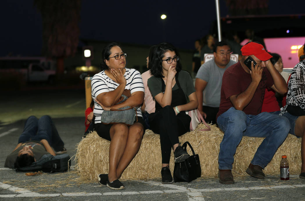 Ana Lilia Cano, left, with daughter Paulina Perez, and Gildardo Leyva, right, wait for relative ...