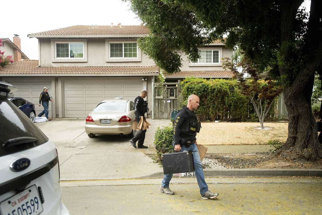 Police officers carry evidence bags from the family home of Gilroy Garlic Festival gunman Santi ...