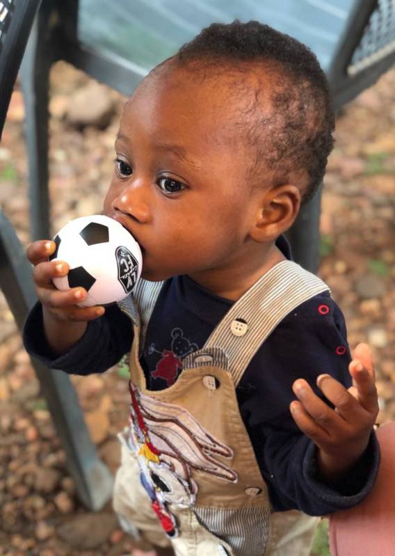 A boy at the Vima Orphanage in Tsibu-Bethel, Volta Region, Ghana kisses a donated Lights mini s ...