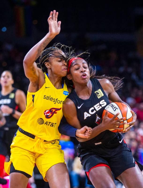 Indiana Fever guard Kelsey Mitchell (0) bodies up with Las Vegas Aces guard Sugar Rodgers (14) ...