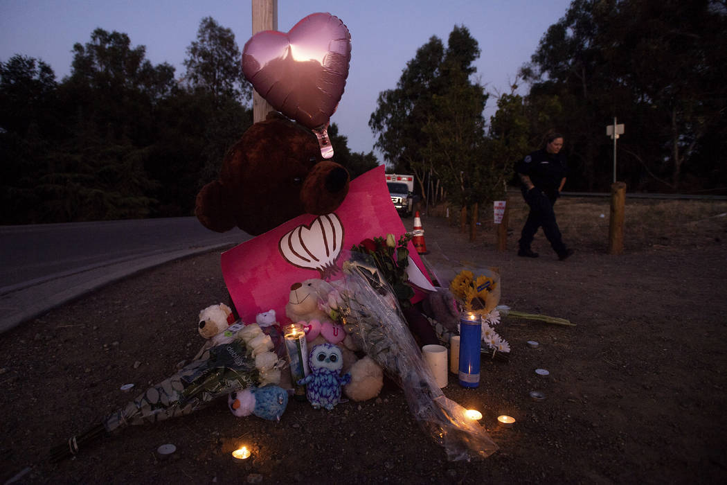 Paramedic Rebecca Mackowiak passes a makeshift memorial for Gilroy Garlic Festival shooting vic ...