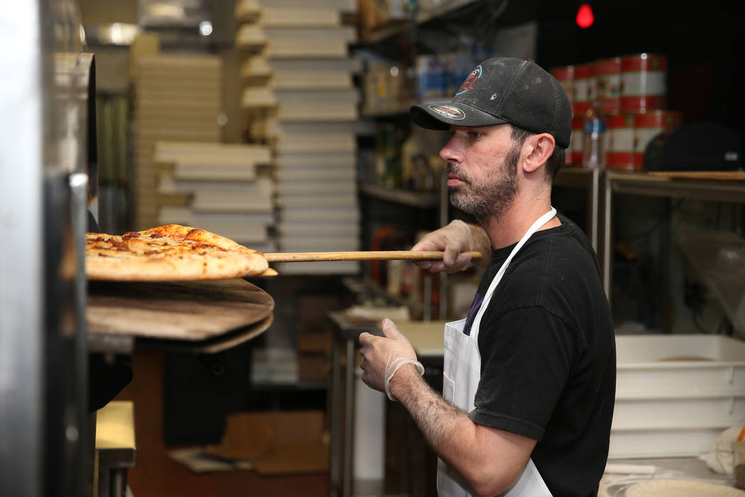 Will Stander prepares a grasshopper pizza at Evel Pie in Las Vegas, Tuesday, July 30, 2019. (Er ...